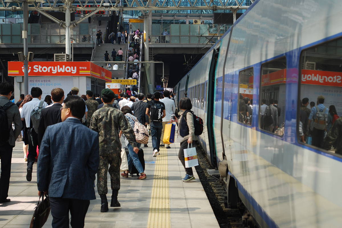 A group of people walking on a platform  Description automatically generated